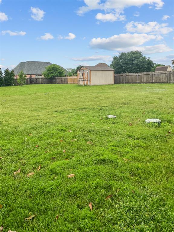 Additional view of yard with a storage shed