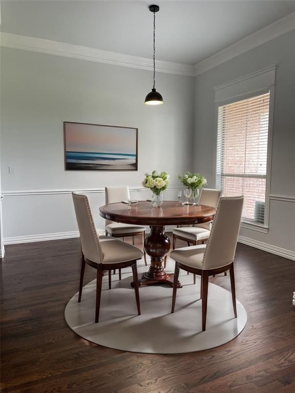 VIRTUAL STAGING Formal Dining rom with ornamental molding and dark hardwood/ wood-style floors