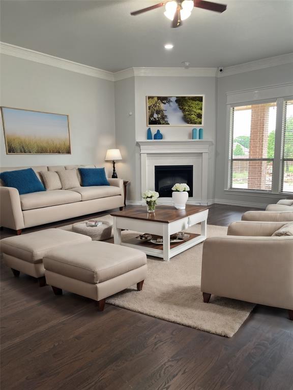 VIRTUAL STAGINGSpacious living room featuring ornamental molding, dark wood-type flooring and ceiling fan