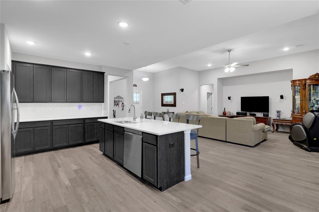 The sleek, dark cabinets contrast nicely with the quartz countertops