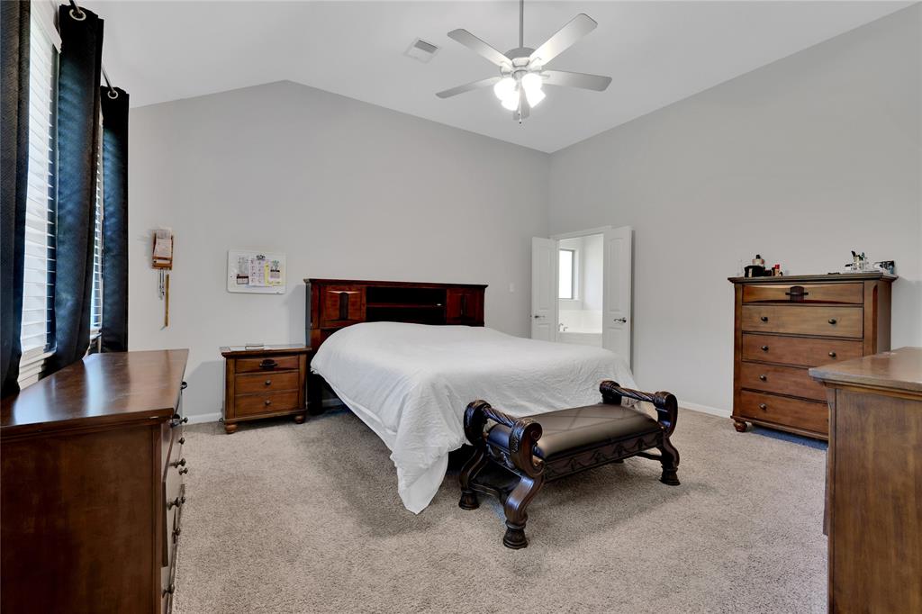 The primary bedroom has high ceilings and its own en-suite bathroom