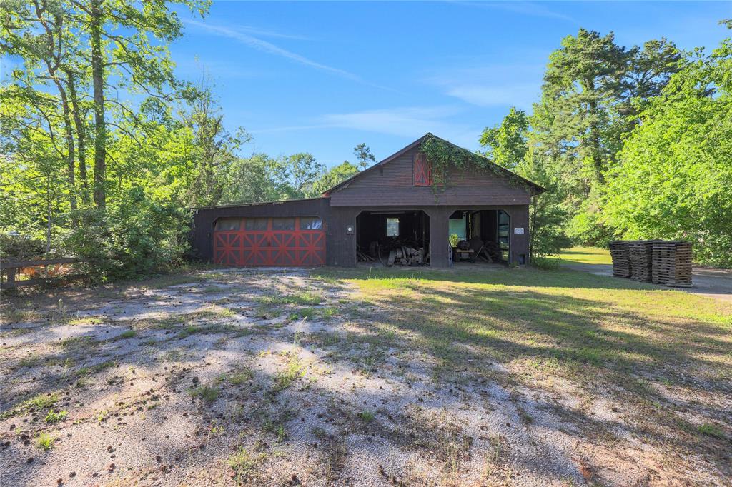 The barn provides storage for equipment or tools and there is an RV pad to the right of it