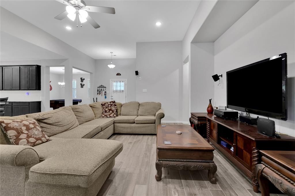 The living area has durable wood look tile flooring