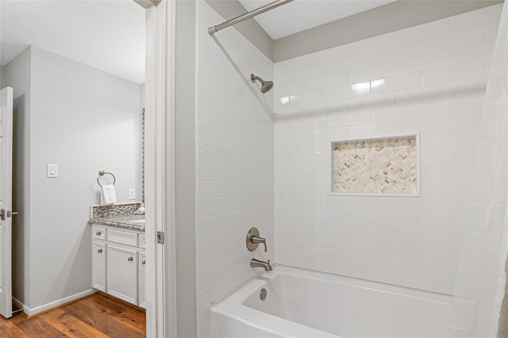 Updated shower/tub welcomes guests to relax.