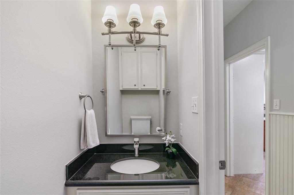 Half bath with granite countertop.  Perfect and efficent off the kitchen.