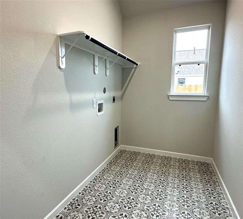 Laundry room with designer tile and shelf for extra storage