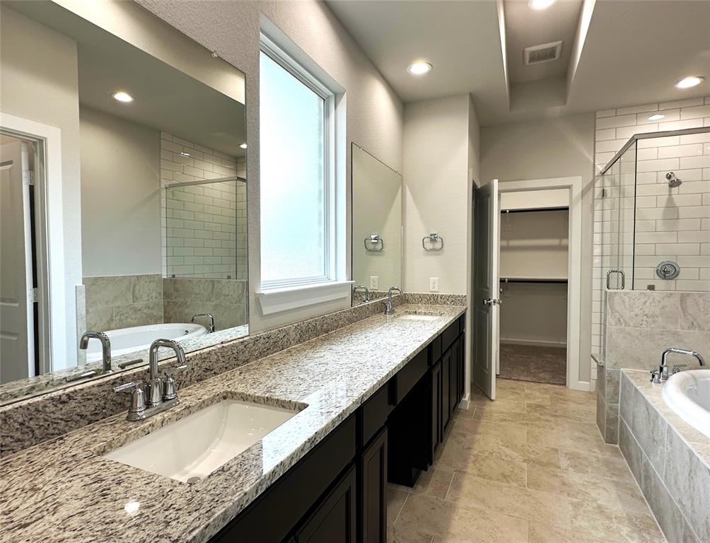 Double sinks- granite countertops- linen closet- walk-in closet and stand alone shower and soaking tub.