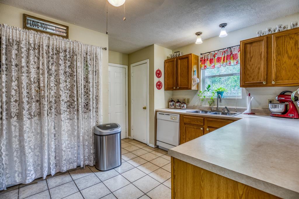 The utility room is behind the curtains & the back door is just around the corner, offering easy access to the backyard.