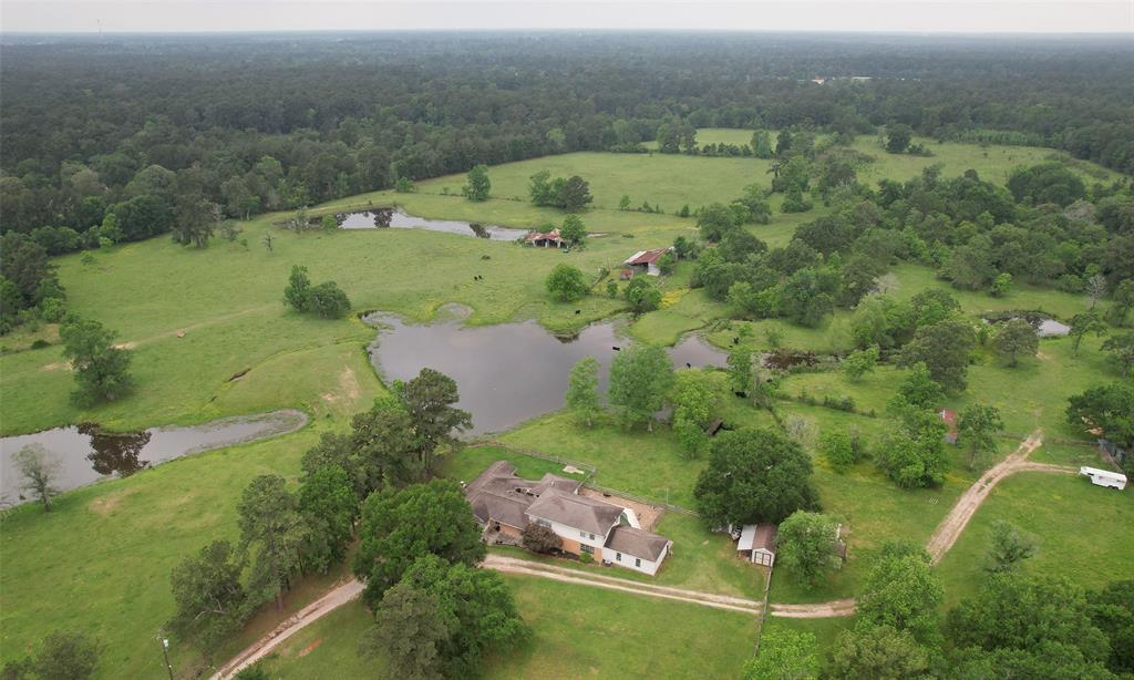 Searching for a fantastic development opportunity? Or, always wanted your own acreage for a family ranch? Then you have to come see this 73.46 acreage property in the BOOMING Magnolia/Tomball area! This property has gently rolling hills, 3 sizable lakes, is about 20% wooded with several mature pastures ready for grazing. There is abundant wildlife including: Whitetail deer, squirrels, ducks, and dove! The lakes are all loaded with bass, and there is an ag exemption already in place! The property is located just West of Dobbin Huffsmith Rd. and less than a mile East of Spur 149. Just a couple of miles from the Aggie Expressway and the new Woodlands Parkway extension! Property is priced at land value.  House is fully functional and in good condition, but could be considered a tear-down to accommodate development or construction of your future dream home!