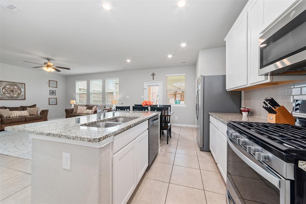 Beautiful kitchen with granite counter tops and tons of cabinetry.