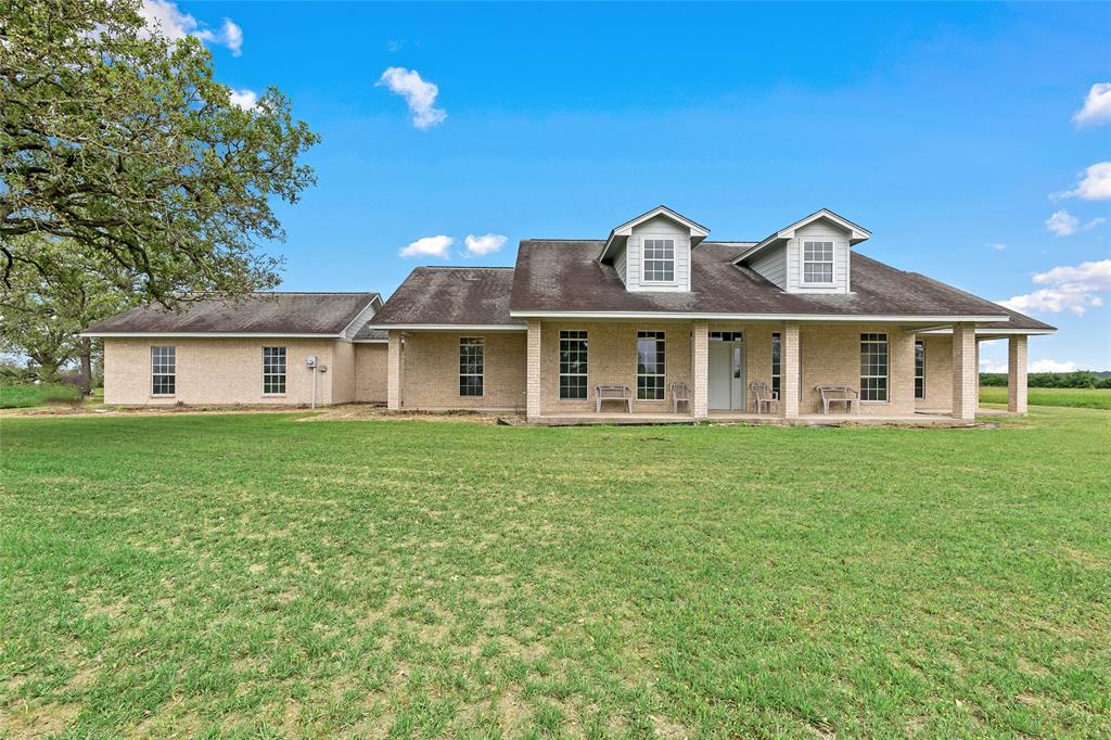 Calling all Aggies! This stunning property is ready to call home, with added land potential to make all of your dreams come true! Located just 35 mins from College Station, and nestled on a generous 5.7+/- acres, this spacious 3bd/2ba home offers over 2,200 sq. ft. of living space, a large garage, aerobic system and approx. 330ft of highway frontage. Featuring both front and back porches, each room also has outside access to their own smaller patios for added convenience. Previously used to house and train show dogs, a 576 sq. ft. building sits behind the main house that offers power and water as well as multiple kennels already built to accommodate your pets. Make game day a breeze from this beautiful property!  Call to schedule your showing today!!!