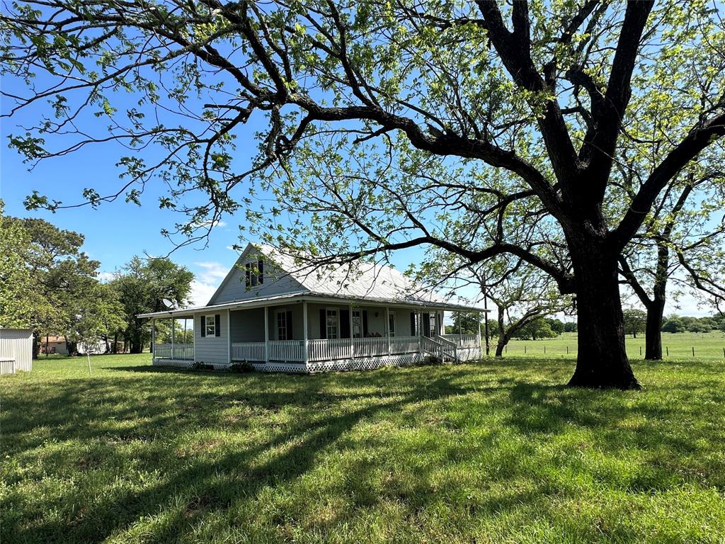 This picturesque 16.789 acres is nestled within a 211-acre tract of land. The property boasts rolling hills adorned with scattered mature trees. At the heart of the property sits a beautifully preserved 1900s Sears & Roebuck Catalogue farmhouse, a true testament to historic craftsmanship & character. This charming 2/1 exudes a rustic elegance that blends seamlessly with its surroundings and a spacious 3/2 double wide mobile home provides comfort and convenience for guests. Surrounded by majestic live oaks, both residences offer privacy & tranquility in a park-like setting. For those with equestrian or hobby farming pursuits, 2 barns provide ample storage space for equipment & supplies, while a charming treehouse/playhouse offers endless opportunities for outdoor adventures & imaginative play. Whether you're seeking a peaceful retreat or a place to create lasting memories with family & friends, this exceptional property offers the perfect blend of history, natural beauty, & comfort.