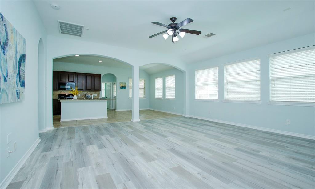 Huge living area with new wood looking floors and beautiful archways.