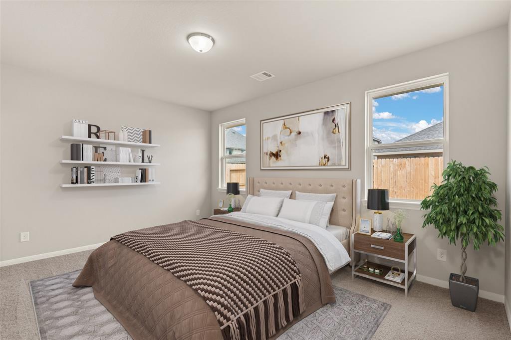 The primary bedroom is generously sized, creating a tranquil and spacious retreat that offers ample room for relaxation. Featuring plush carpet, high ceilings, fresh paint, and large windows that lets in natural lighting throughout the day.