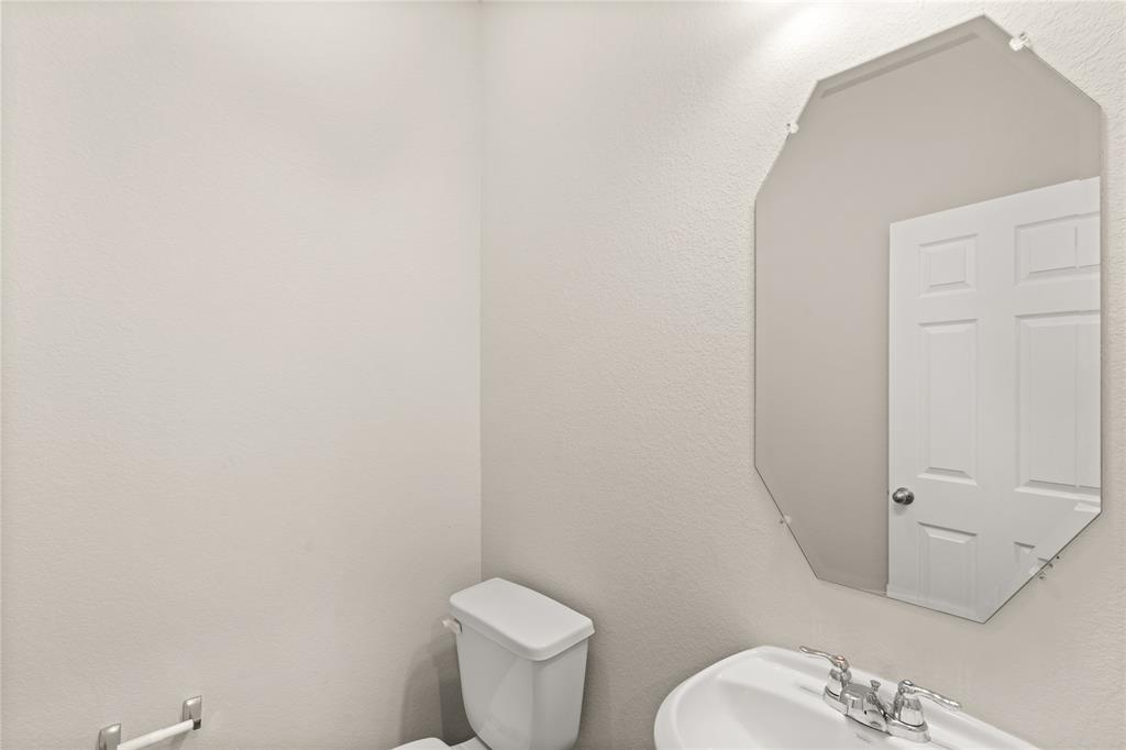 This charming home features a beautifully appointed half bath adjacent to the family room, perfect for welcoming guests and adding convenience to your daily life.