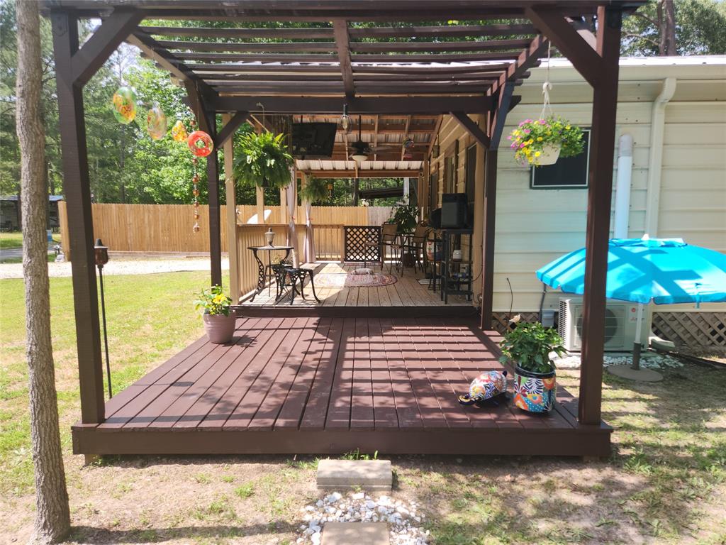 This pergola extends your front porch and the luxury of a larger shaded area by the pool.