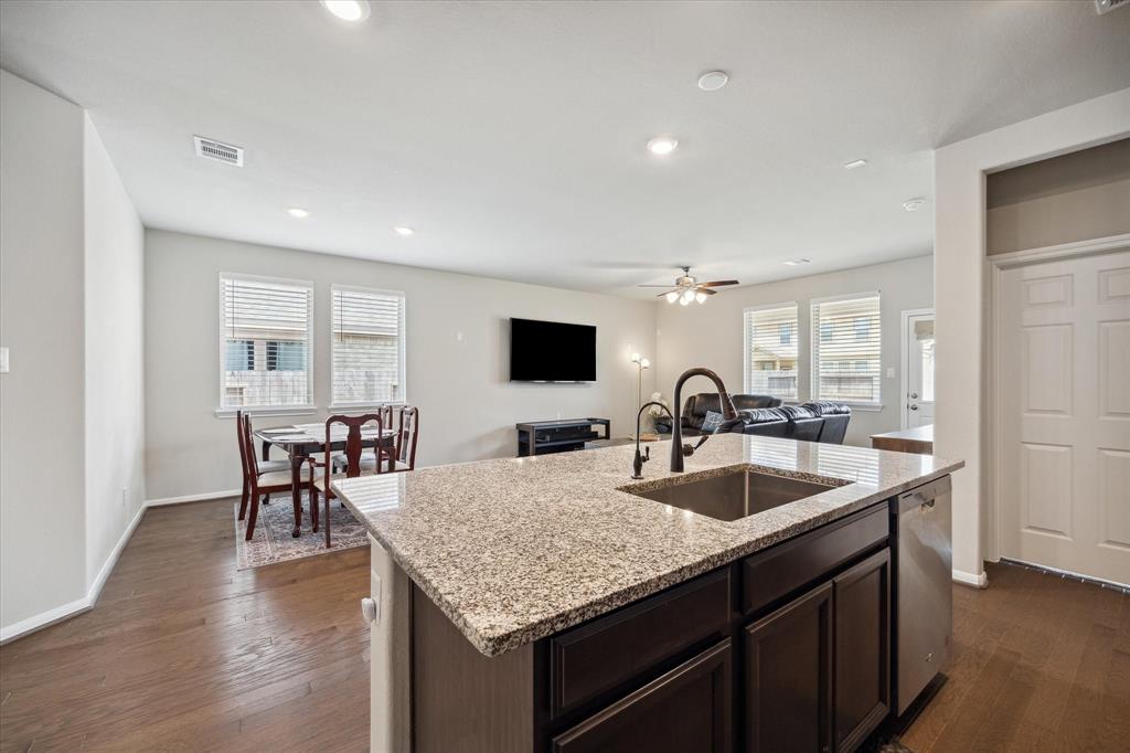 A VERY SPACIOUS OPEN PLAN FOR RELAXATION AND TO FILL WITH GUESTS FOR ENTERTAINING.  THIS SIZABLE GRANITE ISLAND WITH AN UNDERMOUNTED STAINLESS STEEL SINK, ALSO OFFERS PLENTY OF STORAGE SPACE UNDERNEATH.