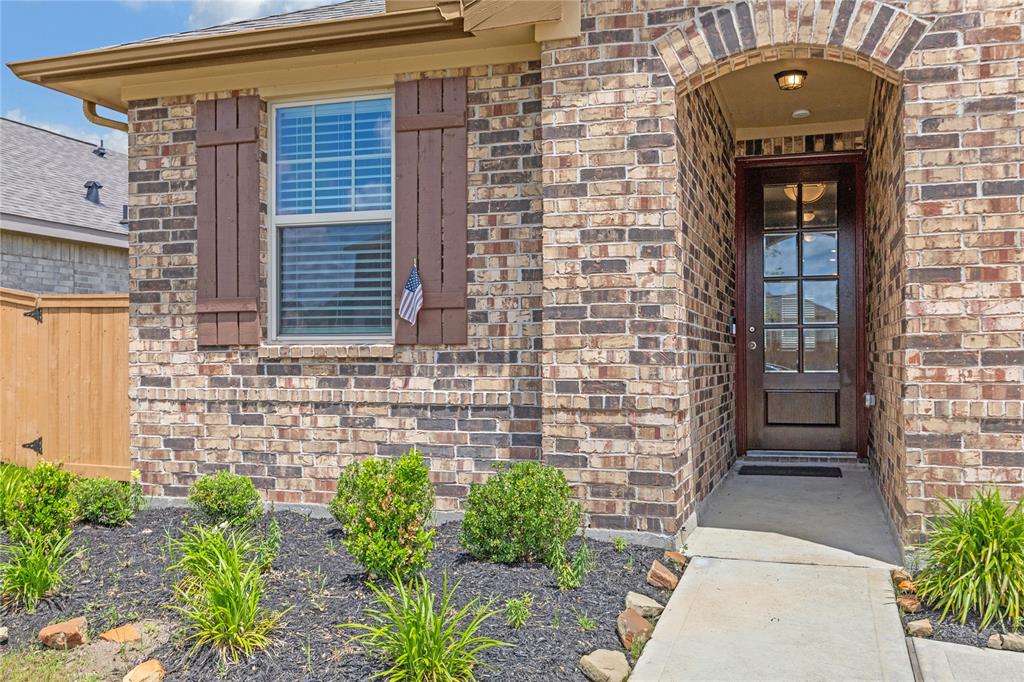 BEVELED GLASS PANES IN AN ELEGENT WOODEN DOOR WELCOMES THOSE WHO APPROACH THROUGH THIS RECESSED ENTRY, WELL AWAY FROM THE ELEMENTS.