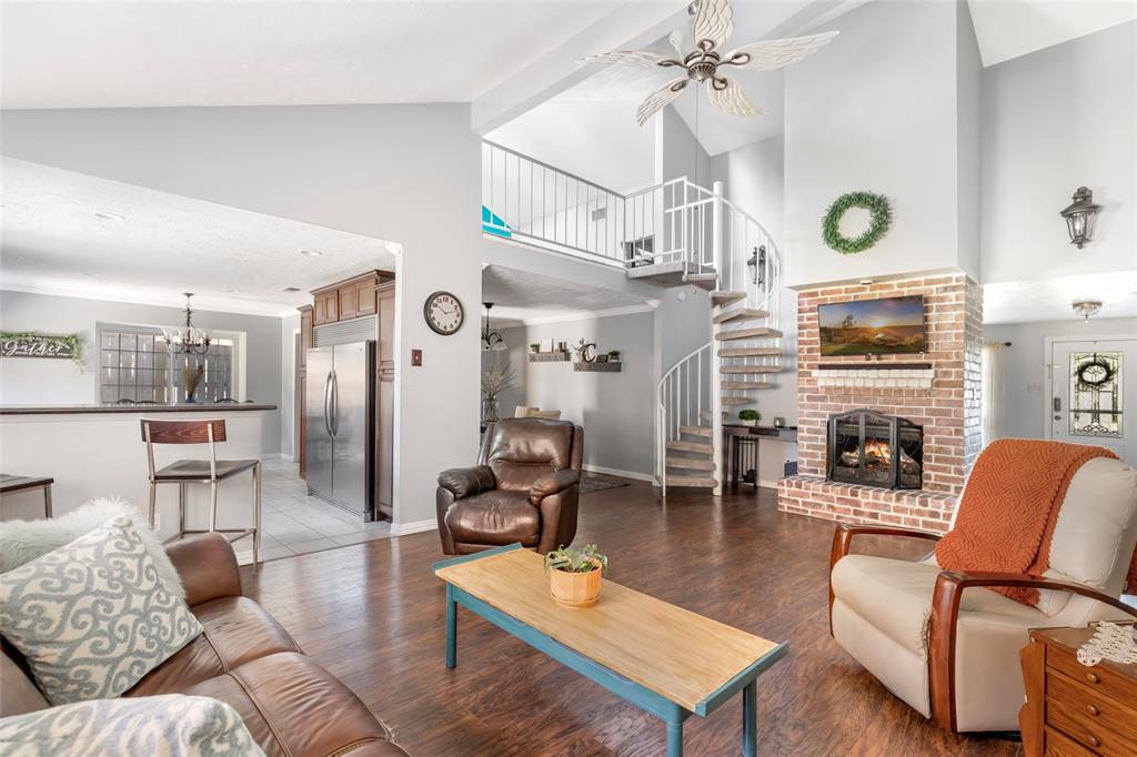 Living room with high ceiling, loft, and breakfast bar