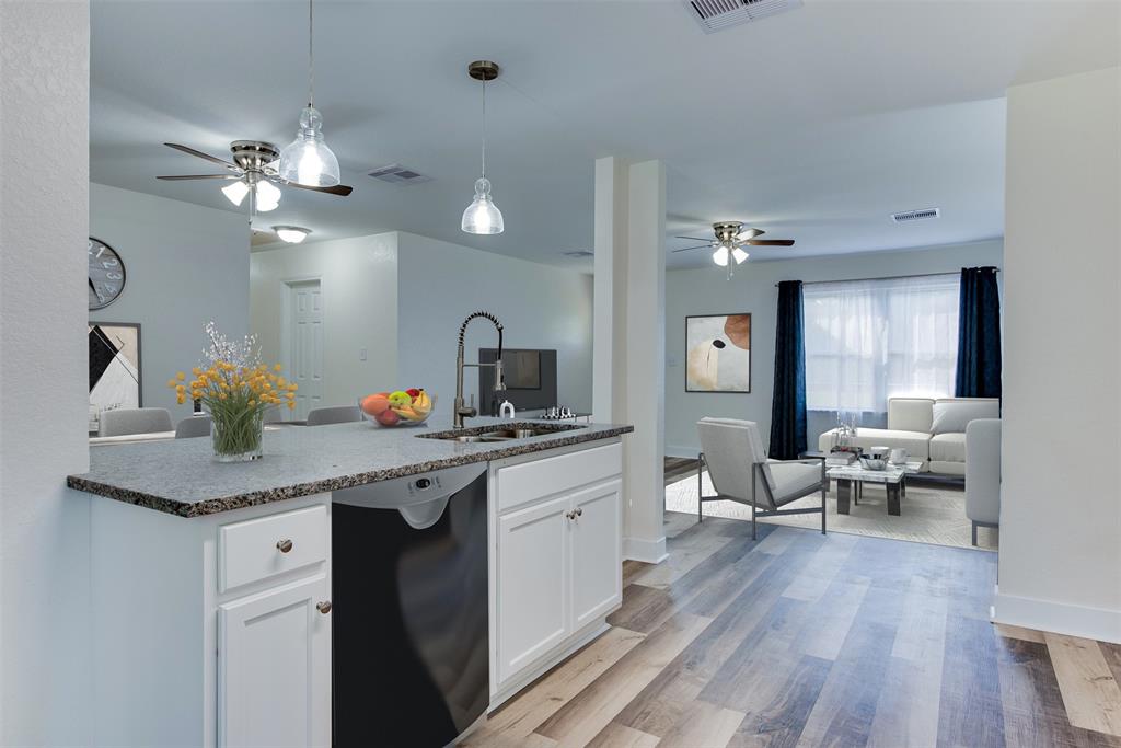 The kitchen\'s eat-in breakfast bar and view of the living and dining rooms make mornings bright. (Some virtual staging may be present)