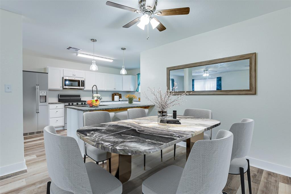 Gather for meals and memories at the dining room\'s breakfast bar overlooking the kitchen. (Some virtual staging may be present)