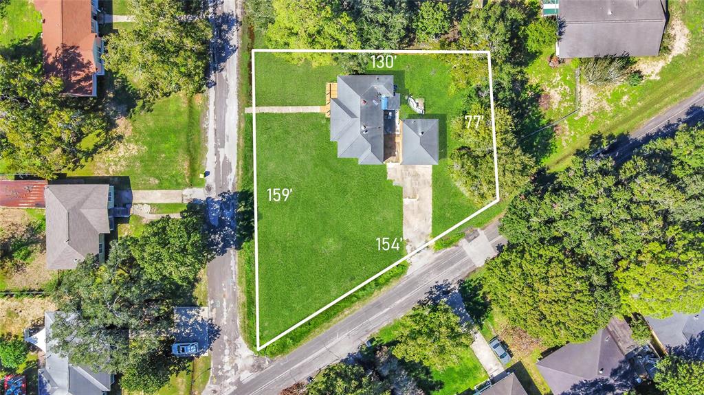 Get a bird\'s eye view of this 3 bedroom, 2 bathroom home\'s coveted corner lot location. Mature trees and lush landscaping surround the property