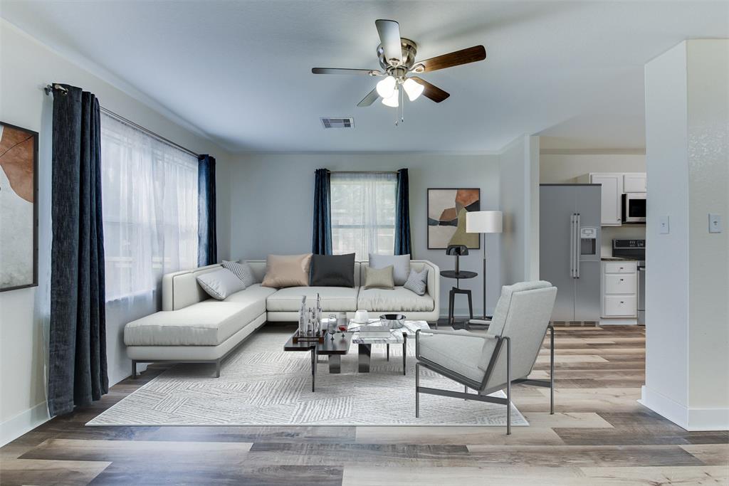 The cozy living room features plush seating and stylish décor. Just beyond, catch a glimpse of the kitchen, perfect for whipping up meals and memories. This open concept makes entertaining a breeze. (Some virtual staging may be present)