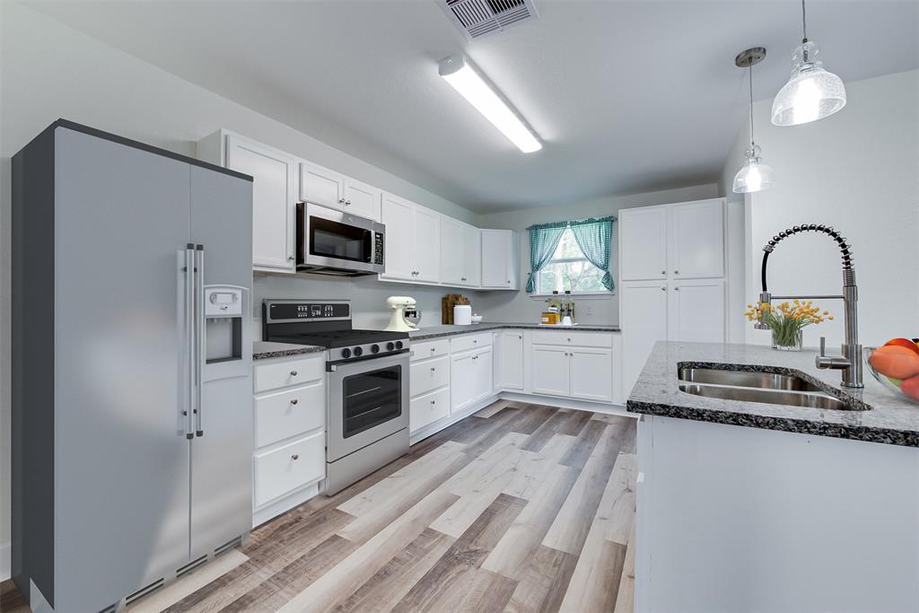 Sleek granite countertops, stainless steel appliances and custom cabinets give the kitchen an updated, chef-ready feel. (Some virtual staging may be present