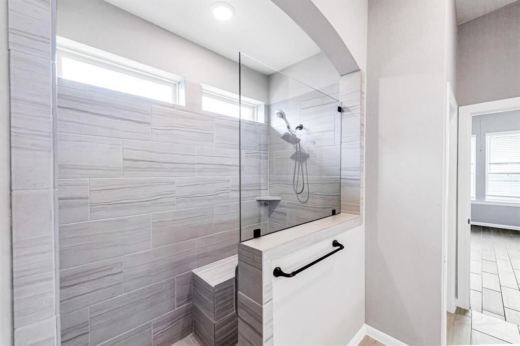 Here\'s a view of the incredible upgraded walk-in shower, featuring bench seating and pocket windows for abundant natural lighting.