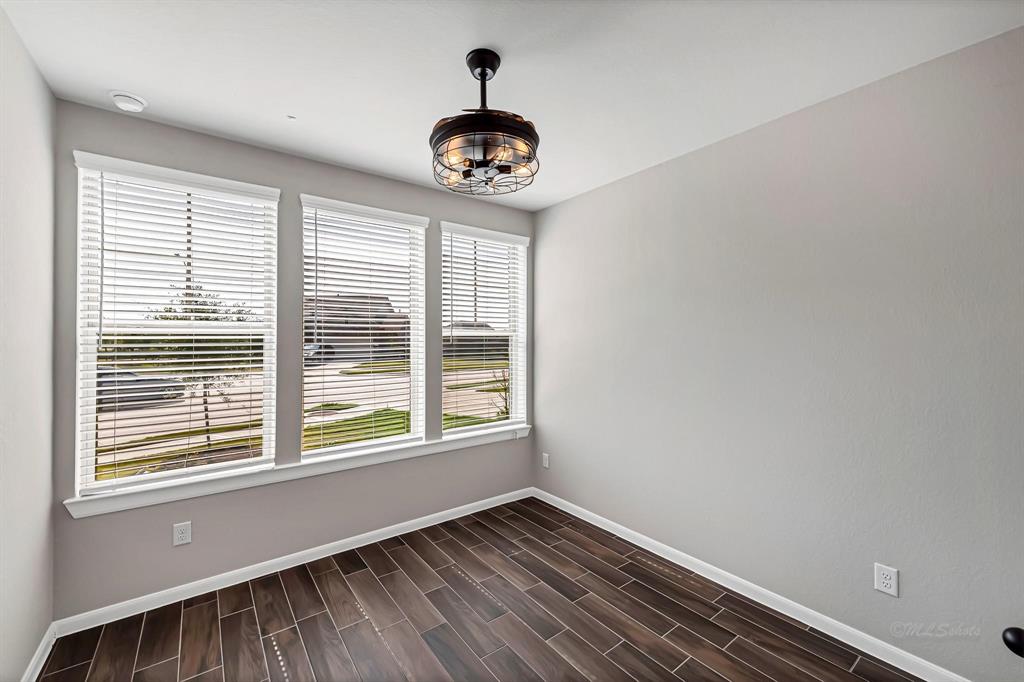 This home offers 4 bedrooms, all featuring the same tile flooring, high ceilings with drop-down fans, and window treatments, ensuring consistency and comfort throughout. This room has front yard views.