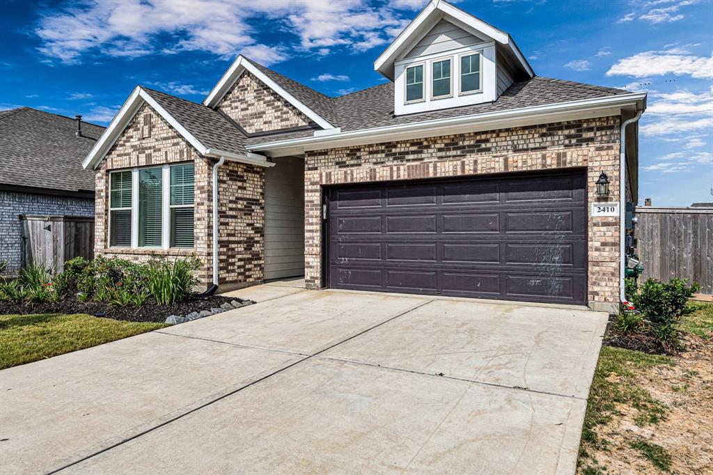 A double-wide driveway leads up to the 2-car garage, providing ample parking space and convenience for homeowners and guests alike.