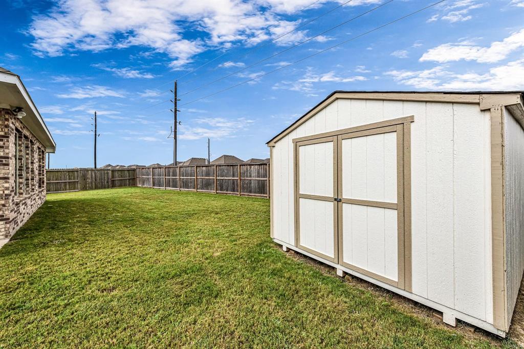 The backyard features a shed, perfect for storage or creating a hobby space to pursue your interests.