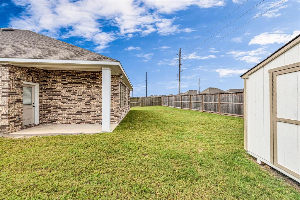 Here\'s another view showcasing the spacious yard that this home offers.