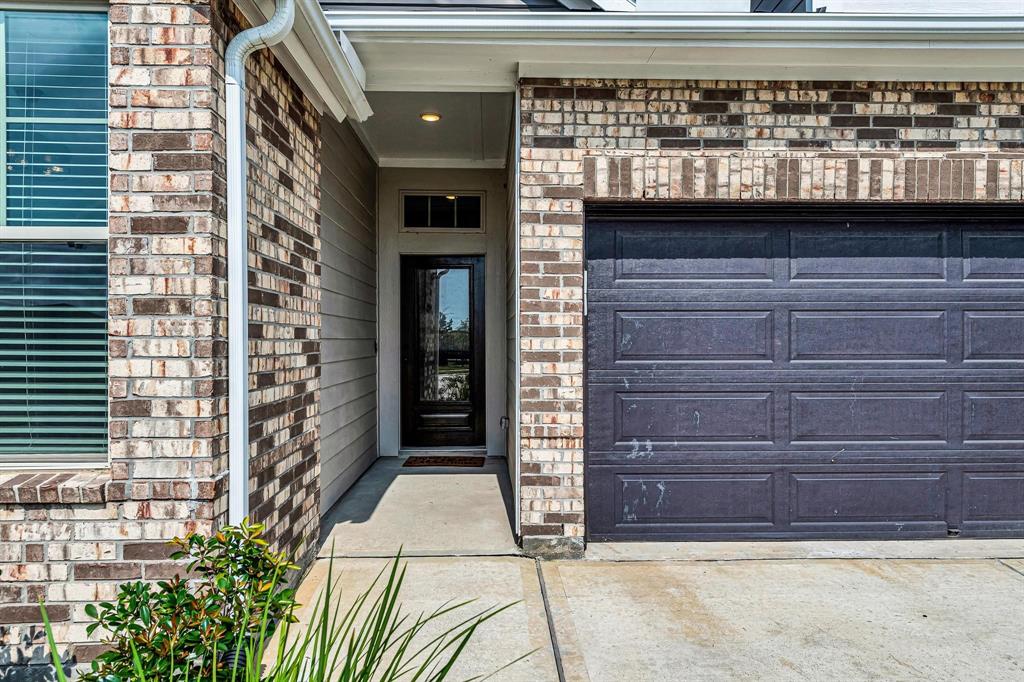 A covered walkway leads up to the front door, providing shelter and adding a welcoming touch to the entrance of the home.