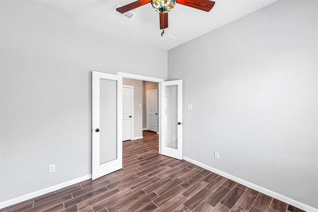 Here\'s another view showcasing the spaciousness of the home office, accentuated by the high ceilings.