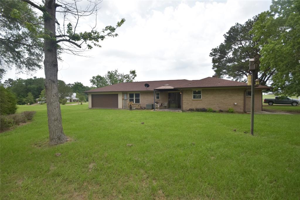 View of the back of the home with a back entrance for a golf cart.