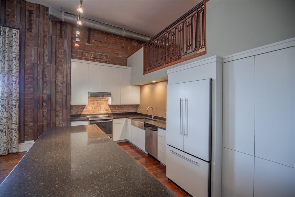 The refrigerator is counter depth and looks like a built-in matching the cabinetry