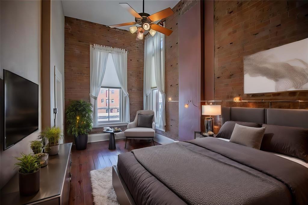 Primary Bedroom Staged with 18 ft ceilings and oversized windows to let in the light