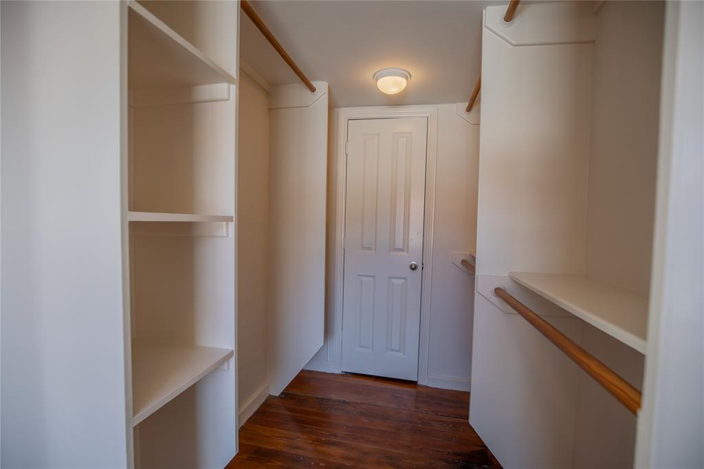 Shelving in the Primary closet and behind the door is the hot water heater plus more storage