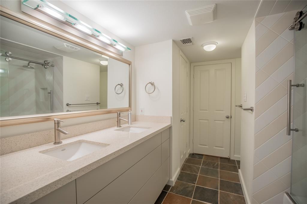 The bathroom has double sinks and large drawers for storage this also has two linen closets