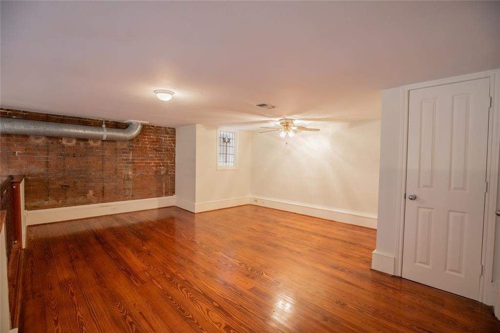 Exposed brick walls and stain glass window in the Loft