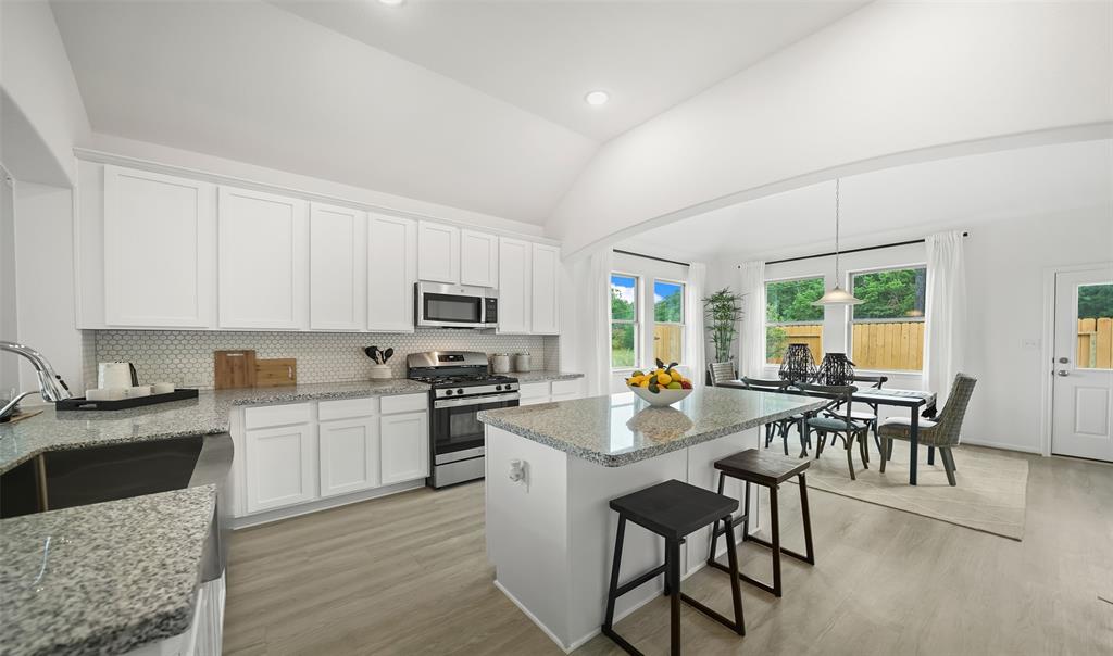 Kitchen features plenty of cabinets and a center island, for extra meal prep space. (*Photo not of actual home and used for illustration purposes only.)