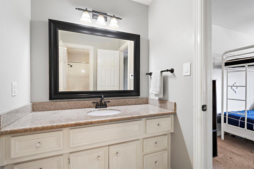 This side of the Hollywood bath is fitted with a full vanity area, ample storage, plus a separate alcove tub and shower.