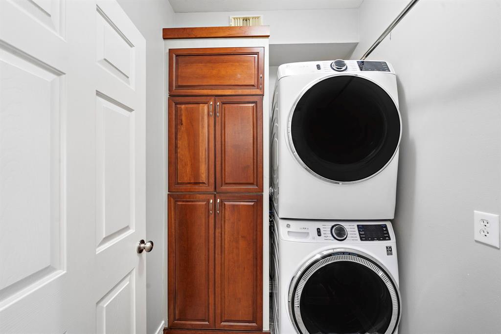 Right off the kitchen and dining room, the laundry room features built-in storage and ample space for a dryer and washer combo.