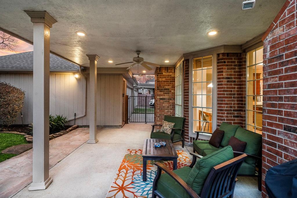 Accessible from the kitchen, discover a backyard oasis with a covered patio, lush landscaping, outdoor lighting, and generous space for lounging.