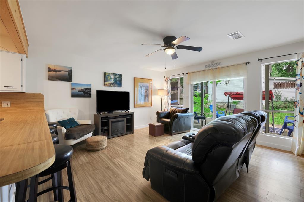 The living area has lots of natural light from the sliding glass doors and windows