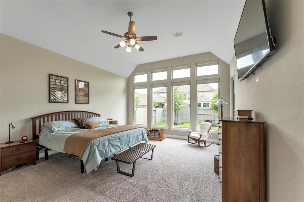 Primary bedroom is very spacious with tall ceilings