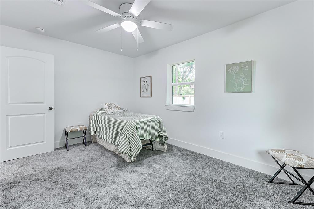 Primary bedroom has ample space and sunlight