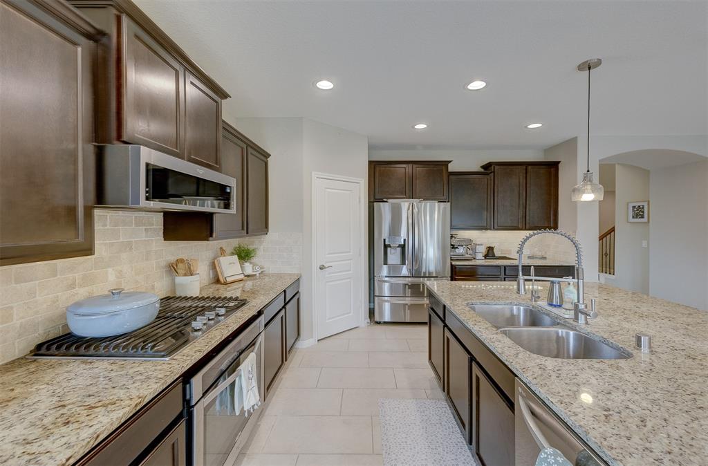 The large pantry is next to the refrigerator.