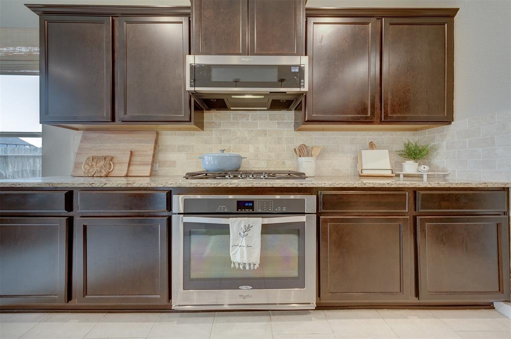 Premium stainless steel appliances include gas cook top, electric oven, microwave and dishwasher.